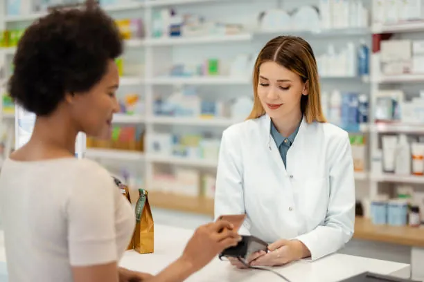 A pharmacy counter taking a payment