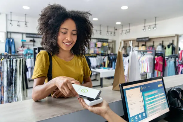 Shop assistant scanning a product at a retail store checkout